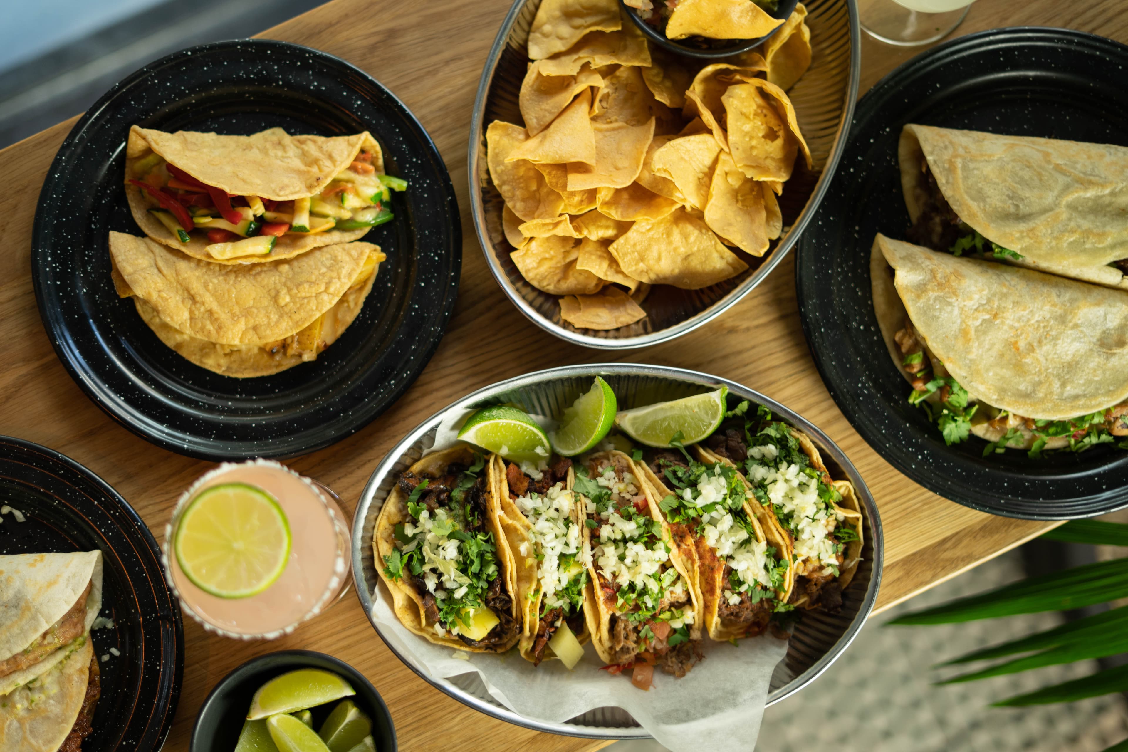 Table with tacos, quesadillas and chips